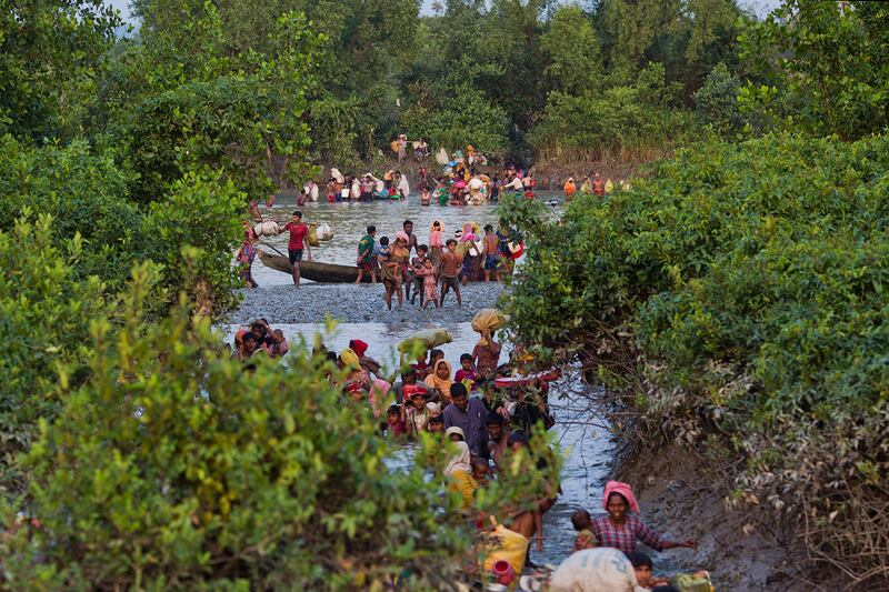 Groups of Rohingya Muslims cross the Naf River on the border between Myanmar and Bangladesh, near Palong Khali, Bangladesh, Nov. 1, 2017.