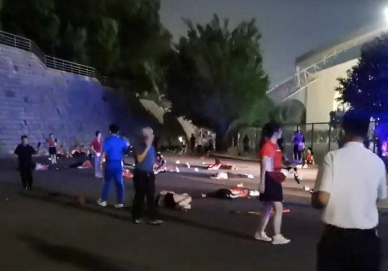 Injured people lie on the road after a car rammed into them outside a sports center in Zuhai, Guandong province, China, Nov. 11, 2024.