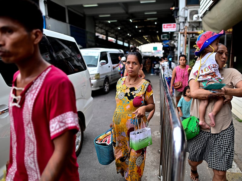 Myanmar nationals cross over into Thailand at the Tak border checkpoint in Thailand's Mae Sot district on April 10, 2024.