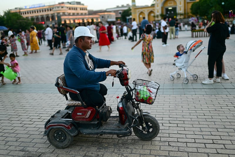 Uyghur people outside the Id Kah Mosque in Kashgar city in northwestern China's Xinjiang region, July 13, 2023.