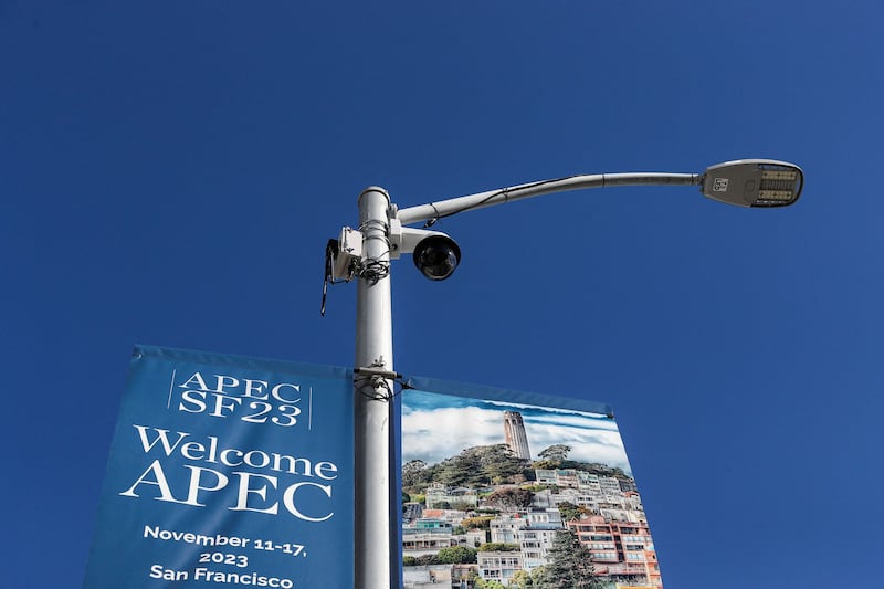 A security camera next to a banner for Asia-Pacific Economic Cooperation summit in San Francisco, California, Nov. 11, 2023. Protesters are planning a large-scale event on Wednesday against the Chinese President Xi Jinping in San Francisco on Wednesday, on the sidelines of the APEC leader's meeting. Credit: Jason Henry/ AFP